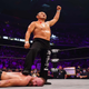 Minoru Suzuki places his foot on the back of Jon Moxley and raises his fist in the air in victory.